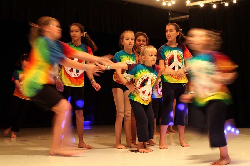 Lily Hayes, 7, prepares to be lifted during the hip-hop number â€œDominoâ€.
