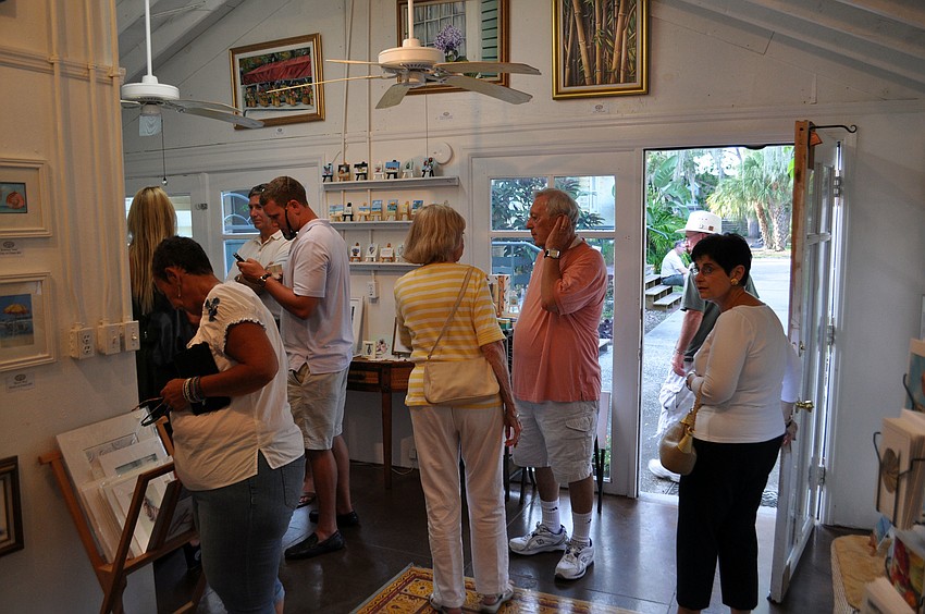 Shoppers explore a gallery during the Towles Court Art Walk