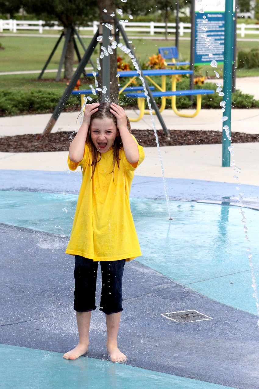 Halee Beckwith, 7, laughs while getting soaked.