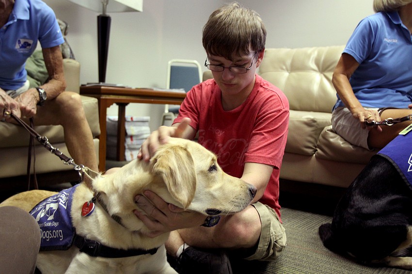 Peter Fisher pets Darby, while visiting Southeastern Guide Dogs Sarasota, Saturday, July 21.