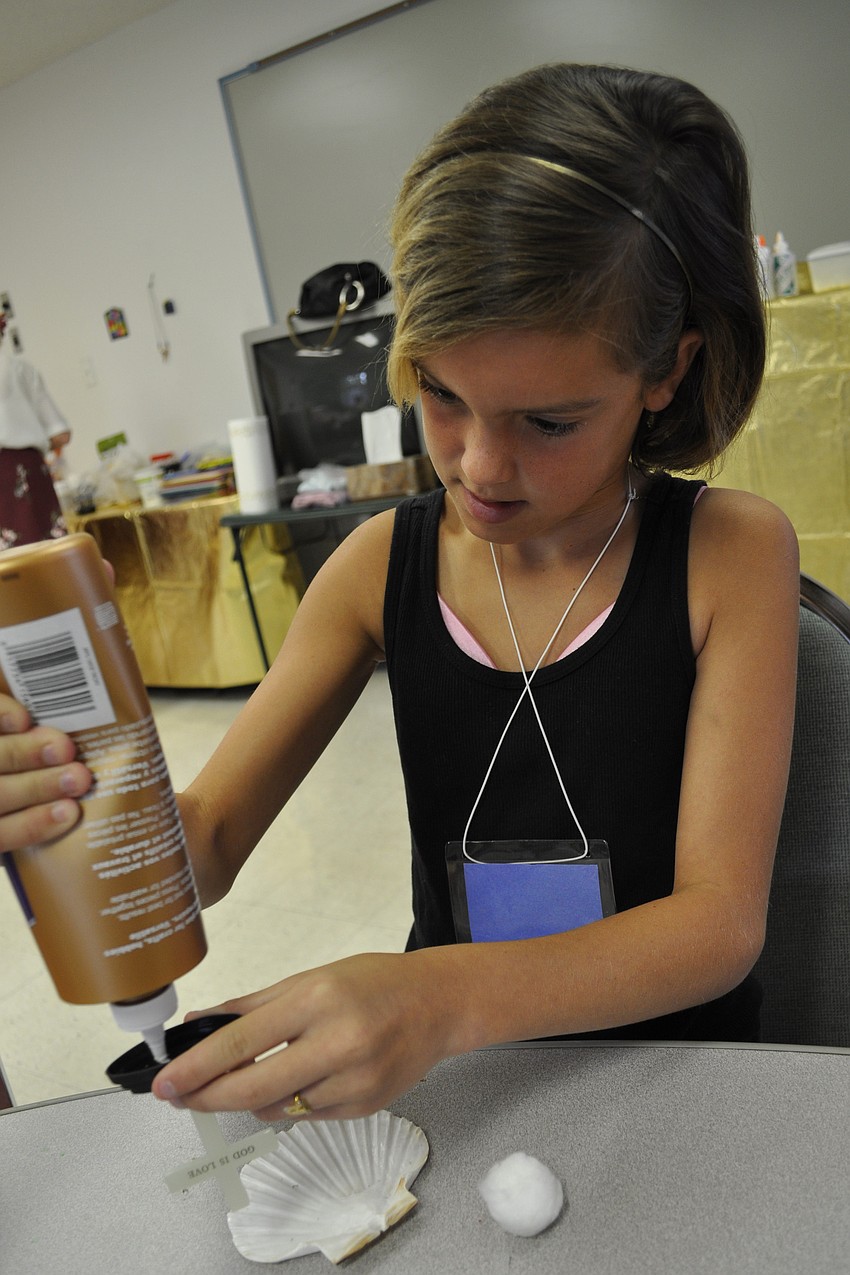 Twelve-year-old Alexis Cowart made a decorative cross during craft time.