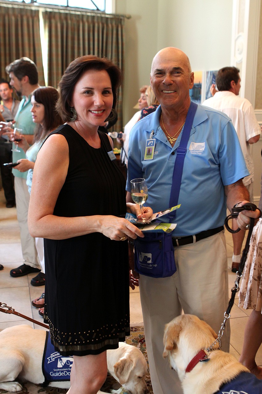 Vicki Collier learns more about the programs at Southeastern Guide Dogs from handler Mike Miller.