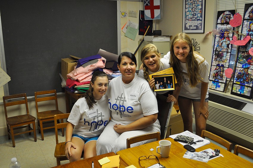 Mercedes Elizalde, Marsha Devitt, Caroline Devitt and Mia Turosienski pose with the first framed family photo of the day.