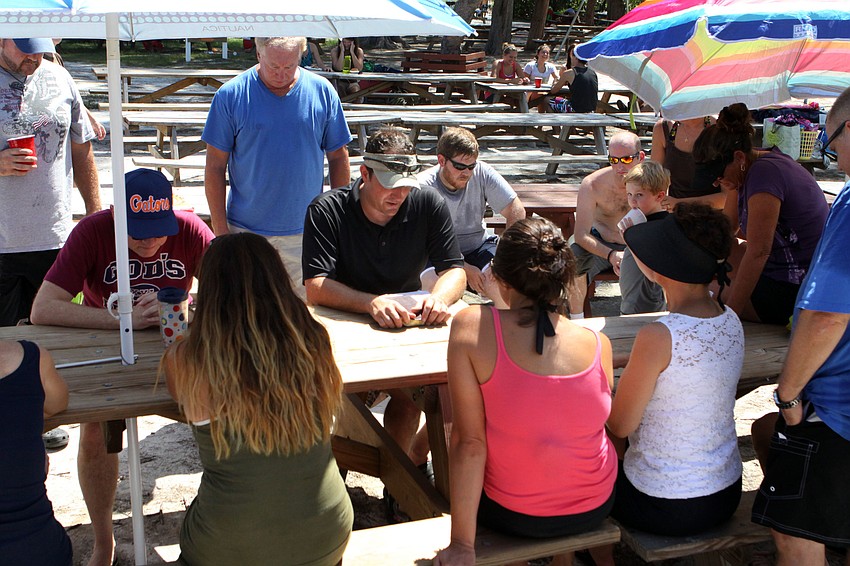 Pastor Craig King leads the group of people preparing to be baptized in a group prayer.