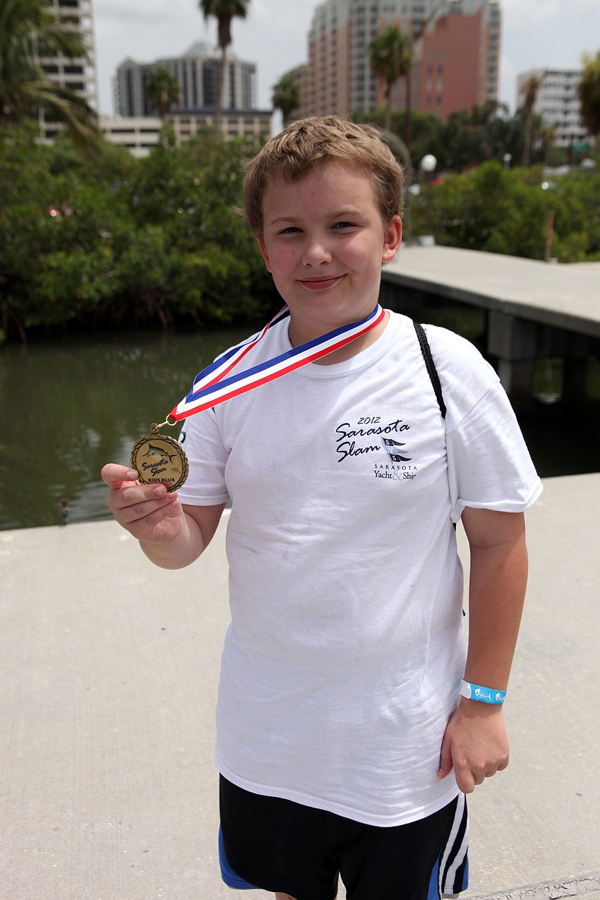 Clayton Garofalo wears his Sarasota Slam medal with pride.
