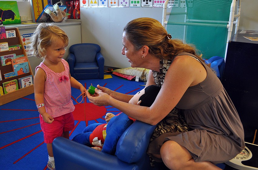 Victoria Maypole, 2, interacts with Sarah Schebel, the new preschool director of St. Boniface Preschool.