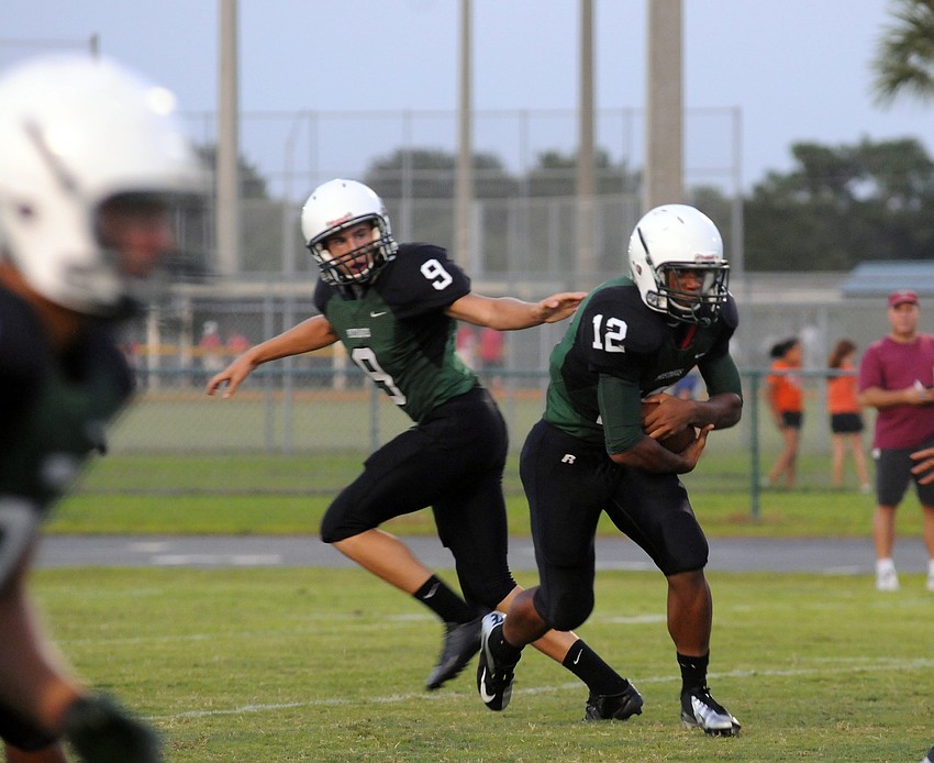 Lakewood Ranch junior running back Chris Pearcey receives the handoff from junior quarterback Jordan Wilson.