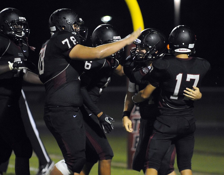 Braden River quarterback Eric Schappacher, second from right, is congratulated by his teammates after scoring a touchdown late in the fourth quarter.