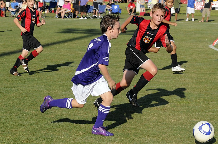 Ten-year-old midfielder Ty Hardy races toward the goal.