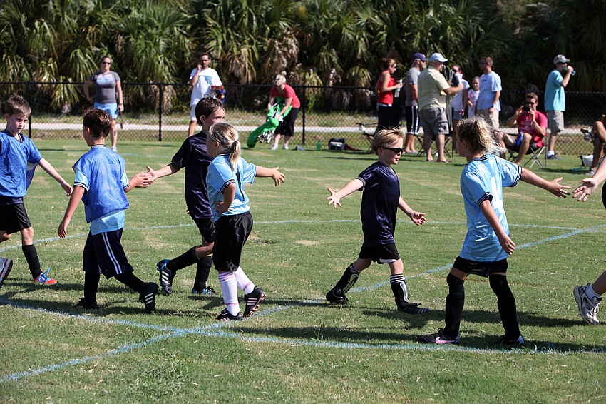 The Thunder and Cosmos give one another fives after playing their first game of the season Saturday, Sept. 8.