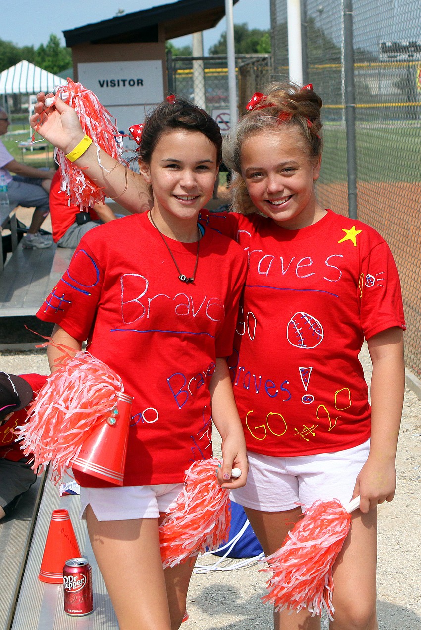 Alexis Pedraza and Haley Kronus cheer on the 1992 Atlanata Braves Friday, April 29 during the Ashton Elementary fifth grade World Series day at Twin Lakes.
