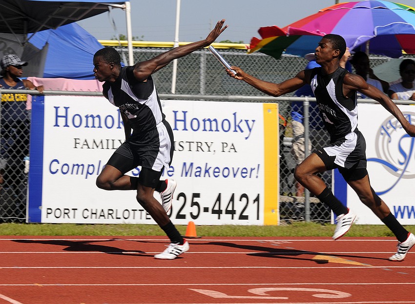 Braden Riverâ€™s Troy Gatling receives the exchange from teammate Justin Ross during the 4x100 relay.