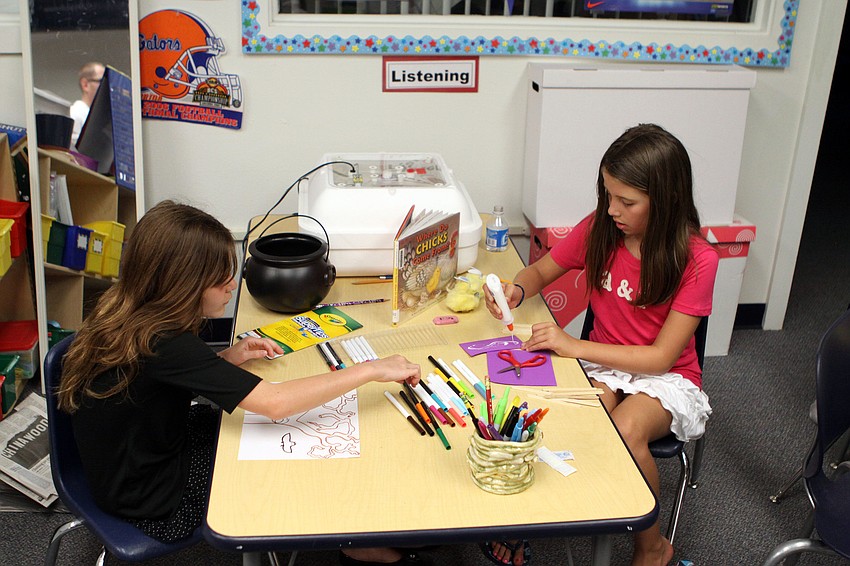Lily Fox, 9, and Alyssa Robbins, 9, have fun drawing and making crafts, Saturday, May 5, at ODA.