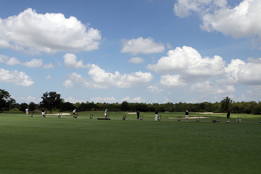 Participants got in some practice swings on the driving range at the Ritz Carlton Members Club golf course.