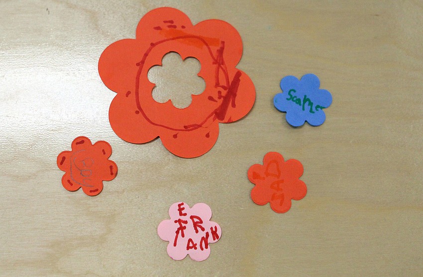 The kids decorated cut-out flowers for decorations on the tables for the Mother's Day tea.