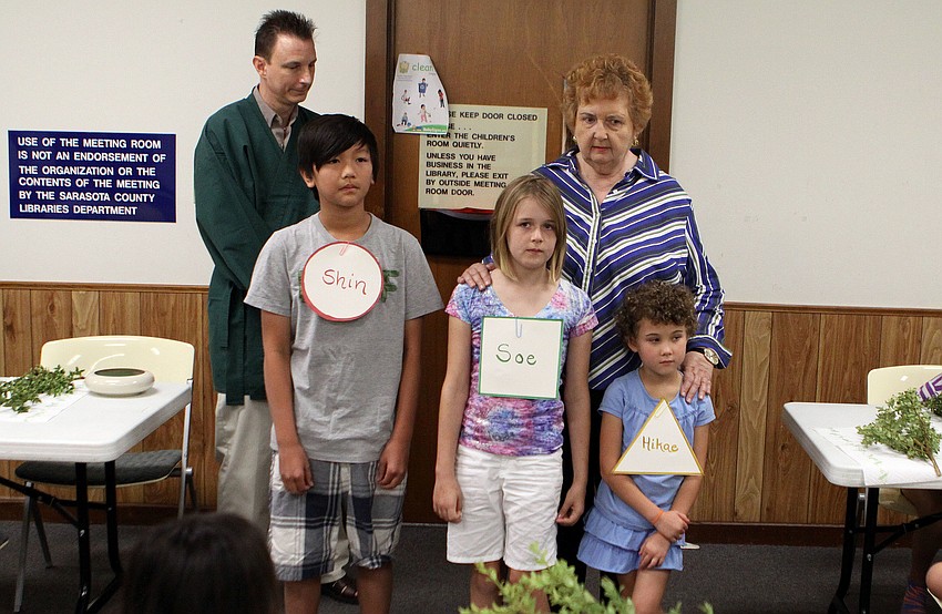 Sensei Pat Bonareck had Tyler Nguyen, 11, Tara Track, 8, and Lilly Mae Stewart, 6, represent the three different aspects of an Ikebana arrangement.