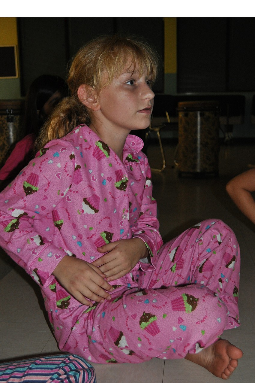 Marissa Baldino, 9, drummed a rhythm on her lap.