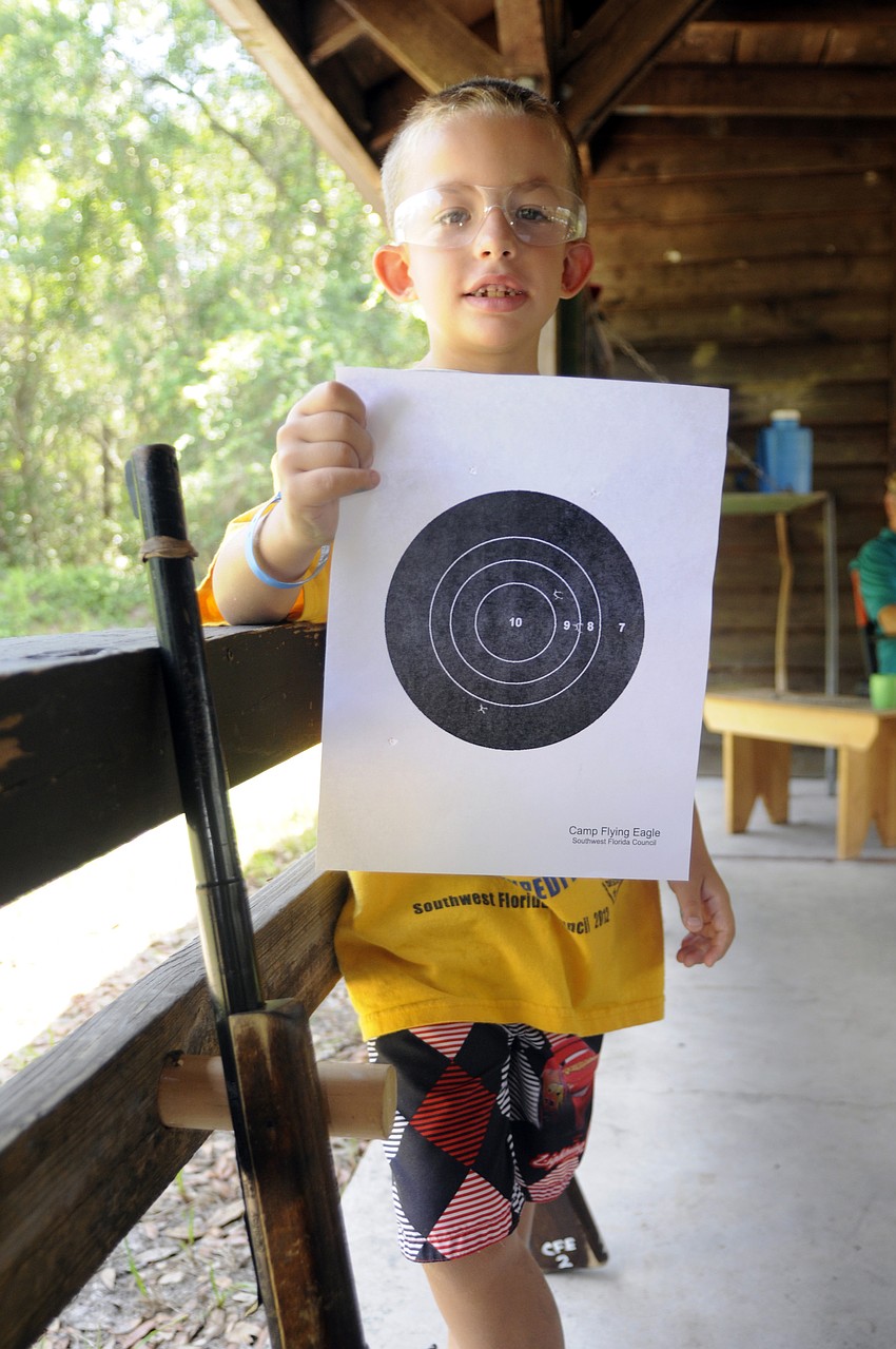 Seven-year-old Sebastian Collado proudly showed off his target from the BB gun range.