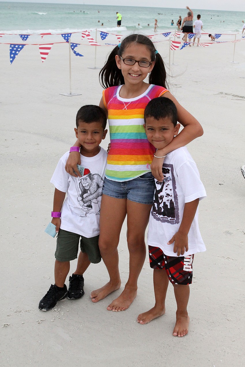 Valerie Malinowski, 10, poses with Joaquin Fernandez, 4, and his brother, Maxey, 5