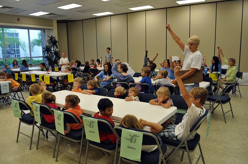 Students cheer during a pre-snack prayer.