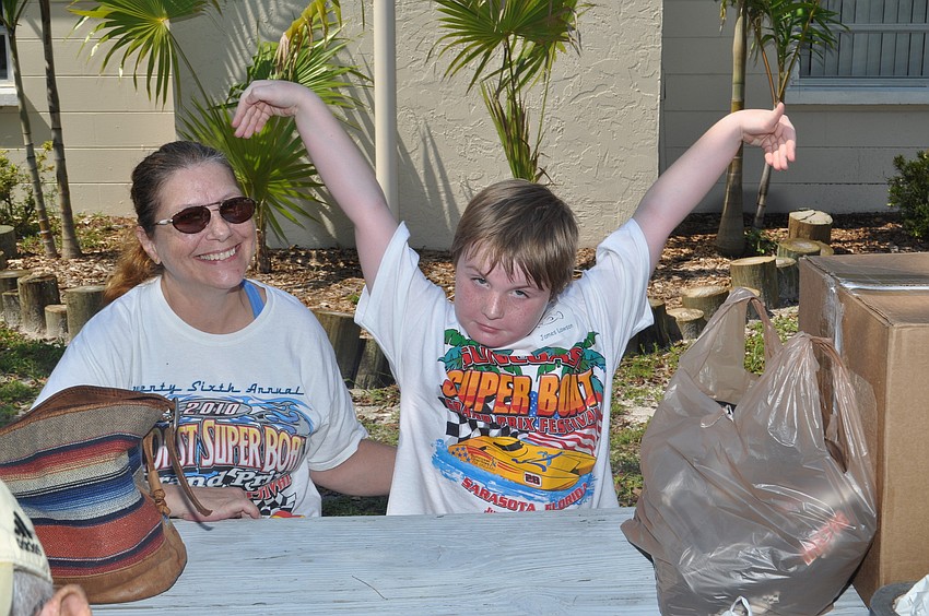 Brenda Blagg and her grandson James Lawson who demonstrates how big the 16-inch trout he caught was