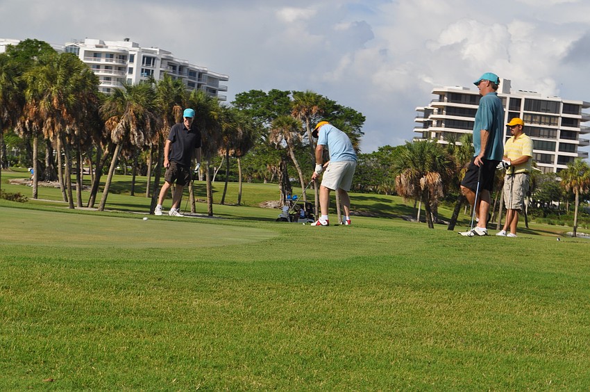 Colin Wilson, Eric Bell and Carter Miville stand-by as David Livengood puts