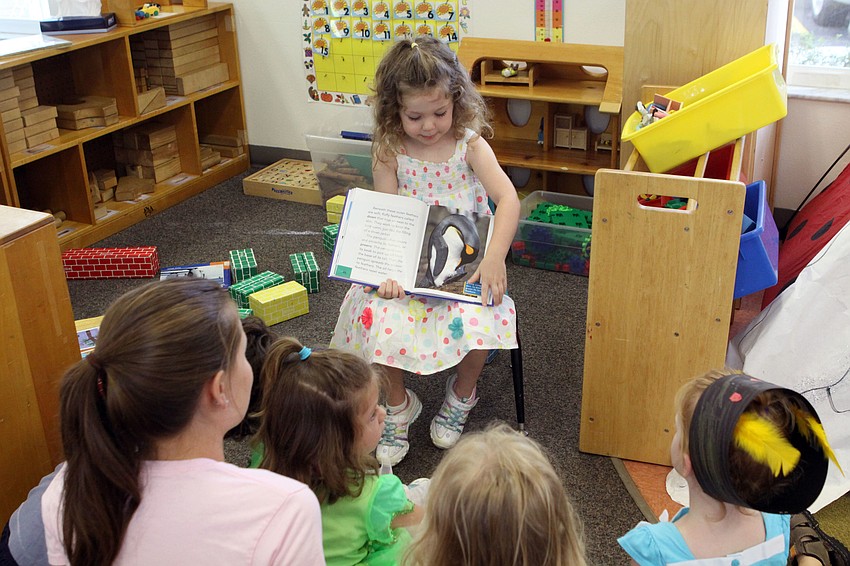 Emma Morris reads a book on penguins to the other campers, Monday, July 16.