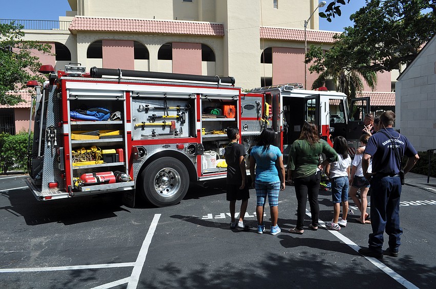 Kids gathered to learn about the fire truck on display.