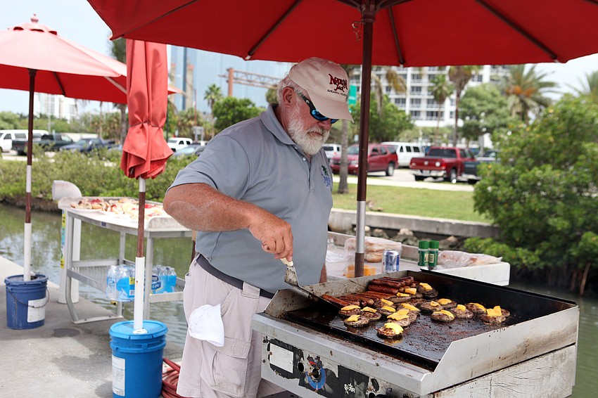 Bill Hankins grills up some hot dogs and hamburgers for the kids to eat after they spent the morning fishing on the Flying Fish.