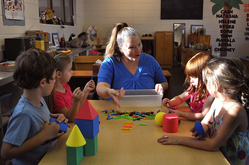Kat Wors leads Cash Murphy, Chesney Beckman, Natasha Antoniuk and Makala Milburn, 4, in a pattern game, Monday, Aug. 20, the first day of preschool for the 2012-2013 school year.