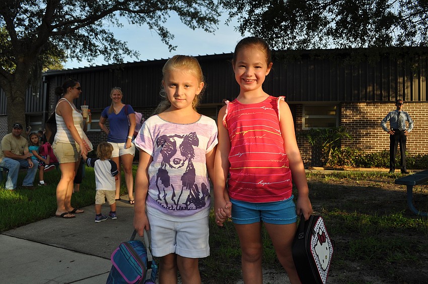Kayla Rogers, first grade holds hands with her friend Miranda Phillips, first grade.