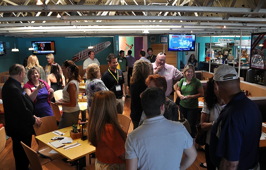 Members of the Sarasota Chamber of Commerce chat amongst themselves at the Power Hour Lunch, Wednesday, Aug. 22, at the Daiquiri Deck on St. Armands.