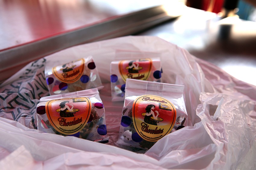 People shopping at the Siesta Key Farmers Market bought groupings of Gabriella cake truffles from a cart Sunday, Sept. 1.