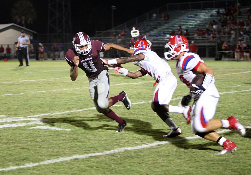Ja Juan Pollock, No. 3, tries to stop Brandom Gomes, No. 11, from tackling Joey Lauro, No. 26, during the Riverview v. Manatee game Friday, Sept. 7.