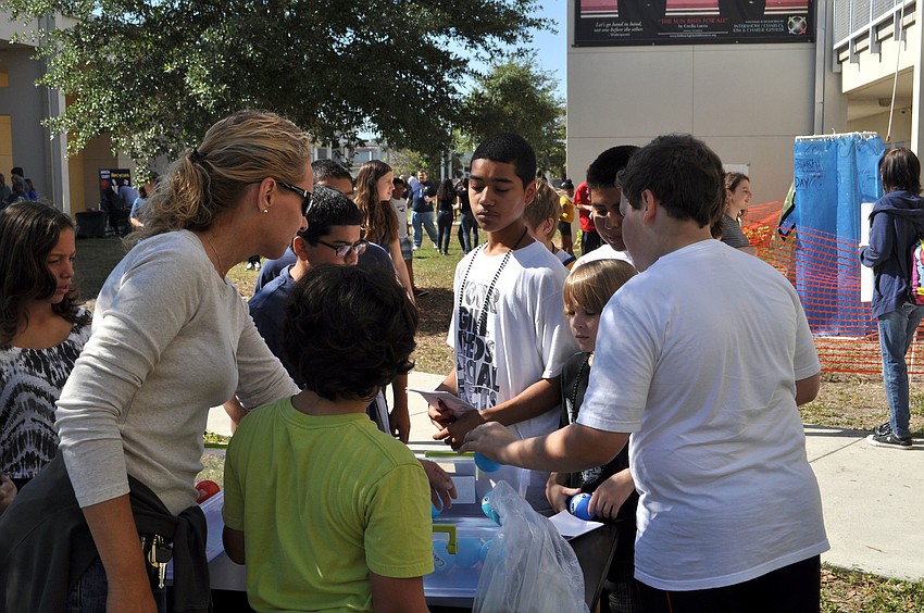 Students surround one of the eventâ€™s many booths.