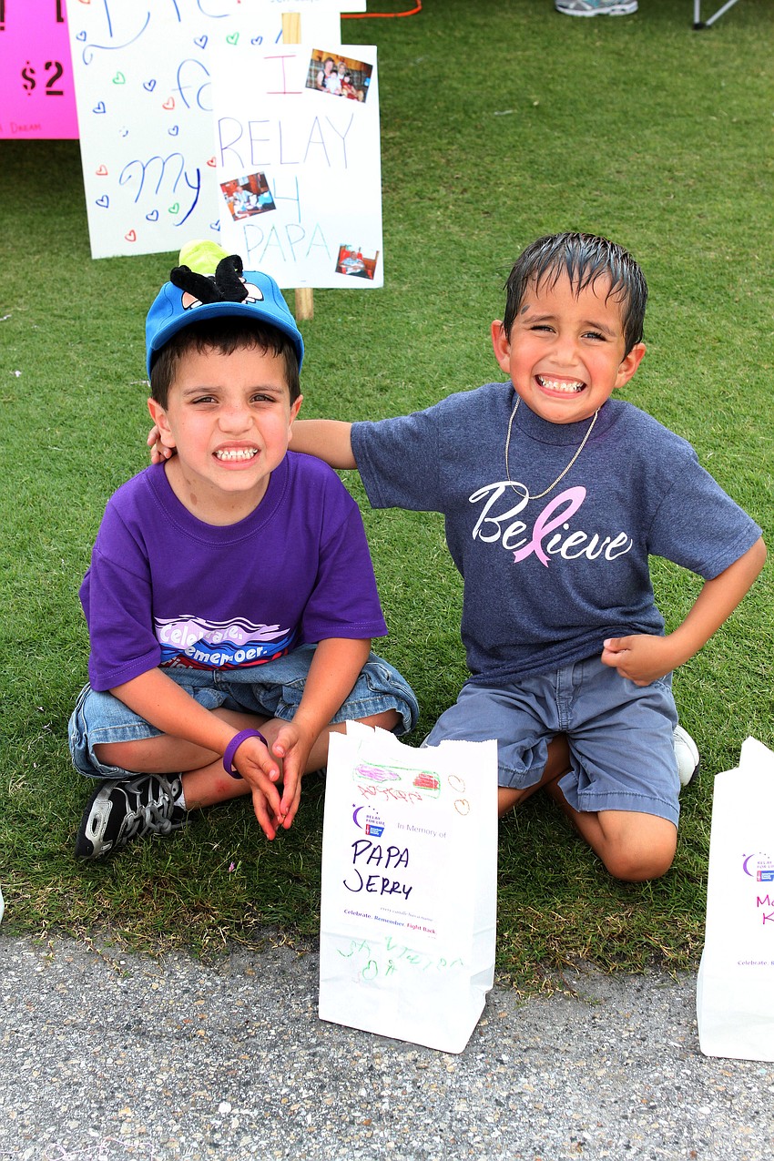 Sawyer Gray, 5, and his cousin, Austin Gray, 5, pose next to the luminary that was put out in honor of their Papa.