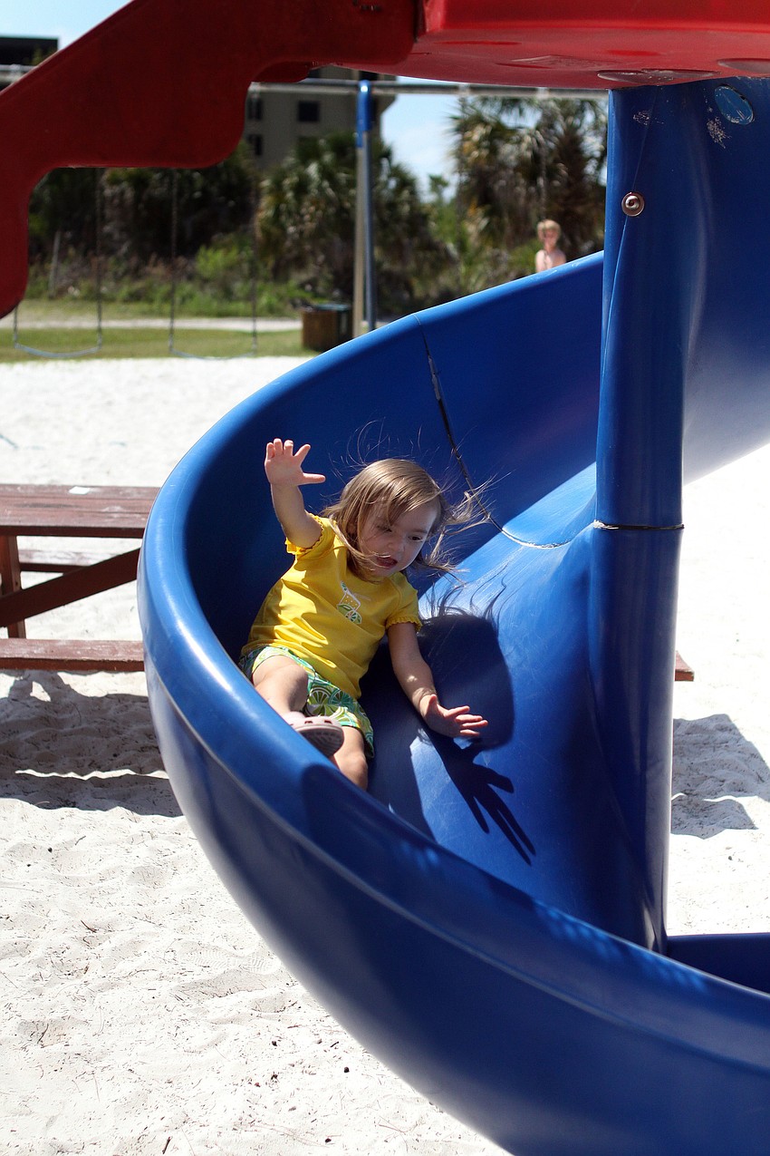 Allie MacFarlane, 2, makes her way down the slide.