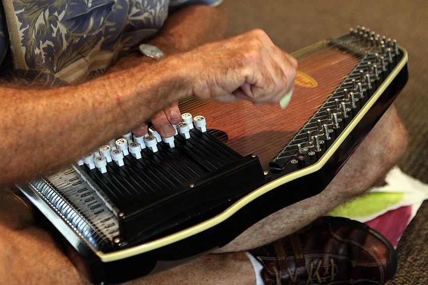 Seth Wertz plays the autoharp during music class, Wednesday, May 9, at St. Boniface.