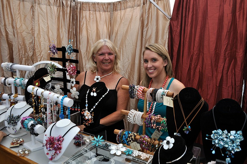 Diane Siggins and her daughter, Michelle Siggins, pose at their booth for Michelle Siggins Accessories, Saturday, May 19.