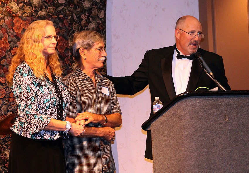 John Gerhardt, chaplain for Sarasota Memorial Health Care System and master of ceremonies, presented an award to Carol and Bill Fletcher, the husband and wife musical duo known as Sparrow, Sunday, June 3, during the National Cancer Survivors' Day event.