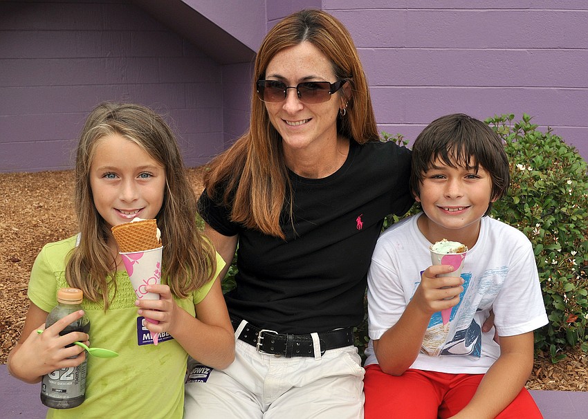 Lisa Hales poses with her twins, Caitlyn and Connor, 8, as they eat ice cream.