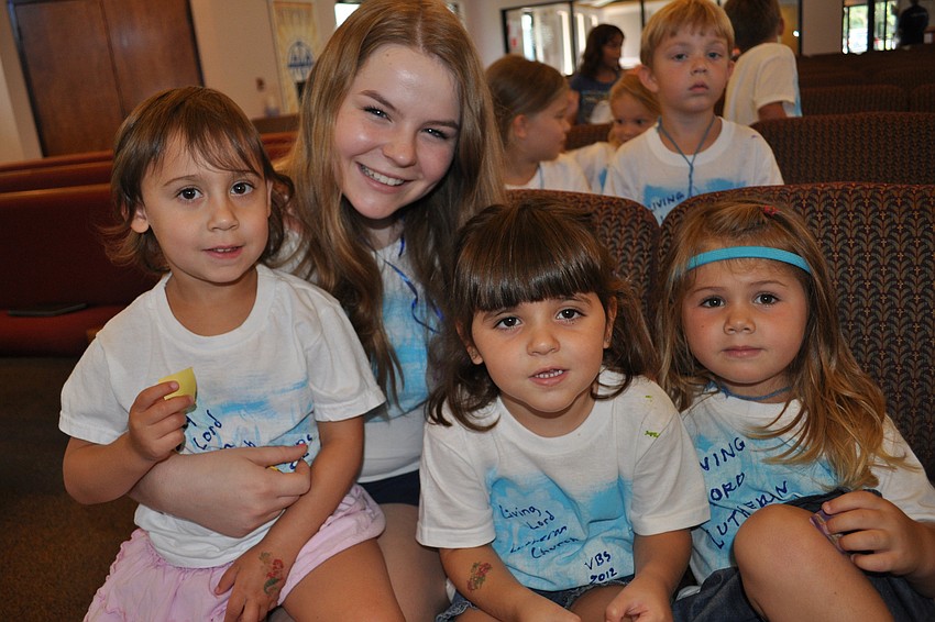 Caitlyn Drizos, Greta Bonifate and Brooke Meyers piled around Jennifer Seminick, during a time of worship.