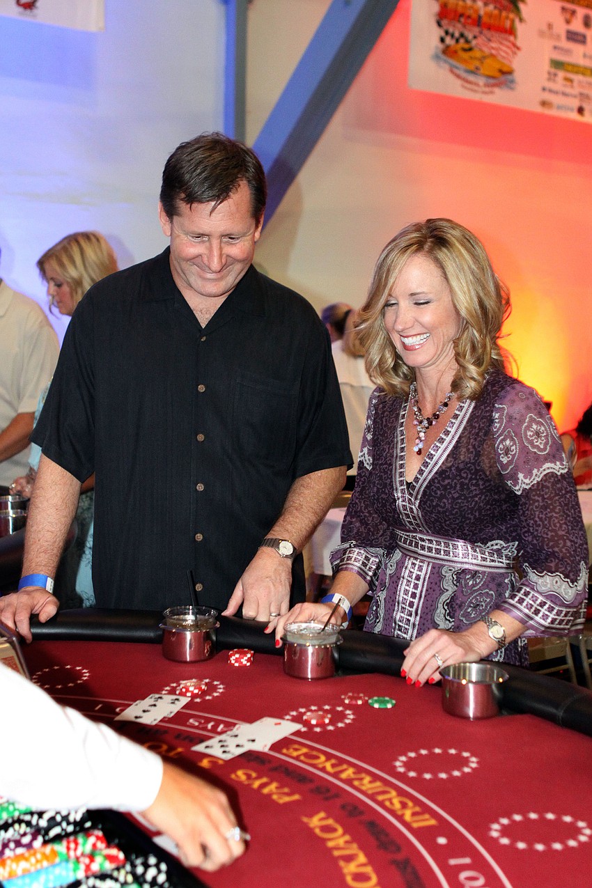 Peter Currin and Jennifer Cline have fun playing black jack, Saturday, June 23, at the Festival Kickoff Party for the 2012 Suncoast Super Boat Grand Prix Festival at the Sarasota Municipal Auditorium.