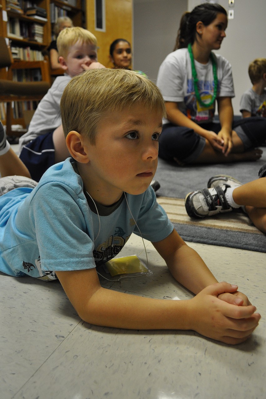 Justin McClung found a comfy spot during Bible story time.