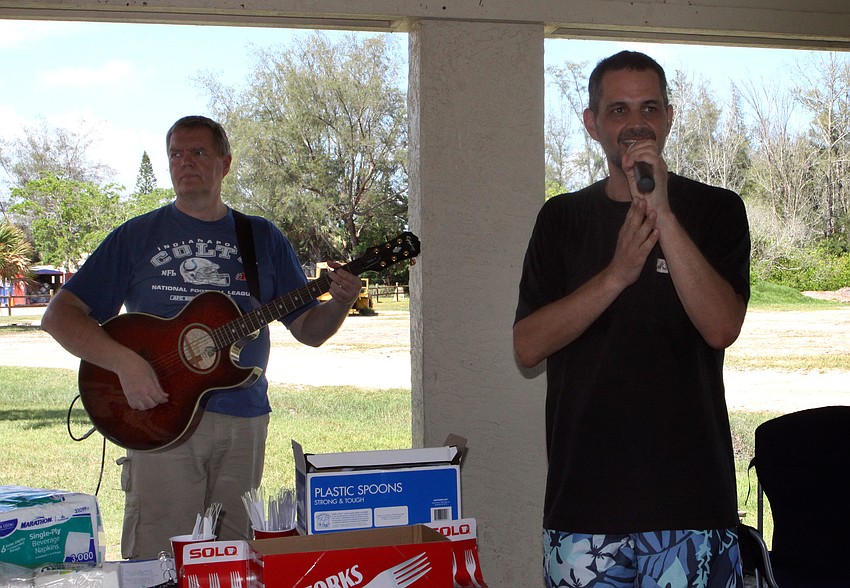 Jarmo Kormu plays guitar while Dan Delzer, Worship Pastor, leads the group in singing, Sunday, July 30, out on Siesta Key.
