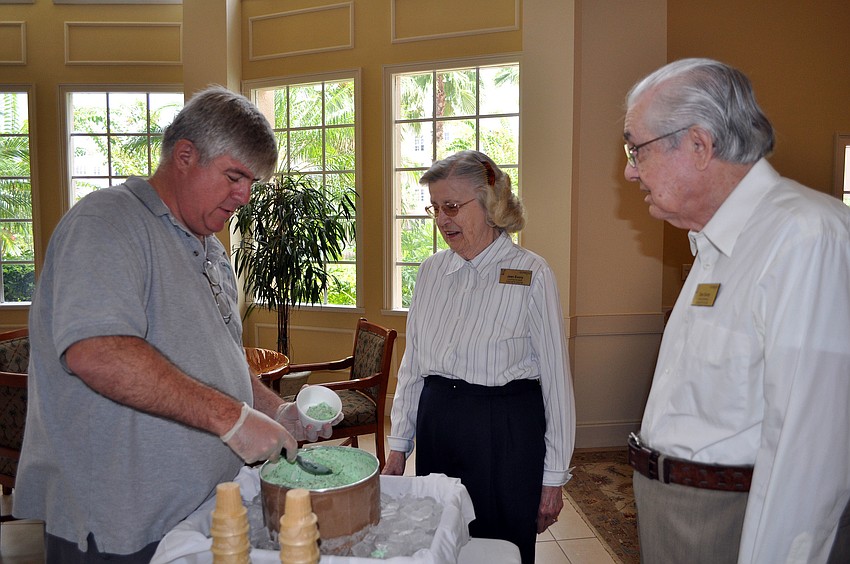 Ben Turoff serves up bowls of mint chocolate chip ice cream to Jean and Don Evory, Sunday, Aug. 5.