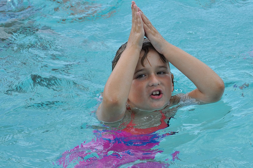 Lily Costello, 7, pretended to be a shark.