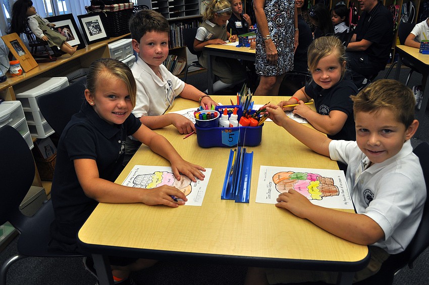 Shelby Liashek, 6, Blaine Bentley, 7, Hannah Scuh, 6, and Luke Flanders, 6, have fun coloring together in their new first grade classroom, Wednesday, Aug. 22, at Out-of-Door Academy.