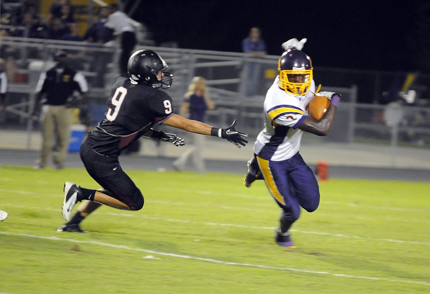 Braden River linebacker Kyle Anderson tries to chase down Booker quarterback Alex Riddle behind the line of scrimmage.