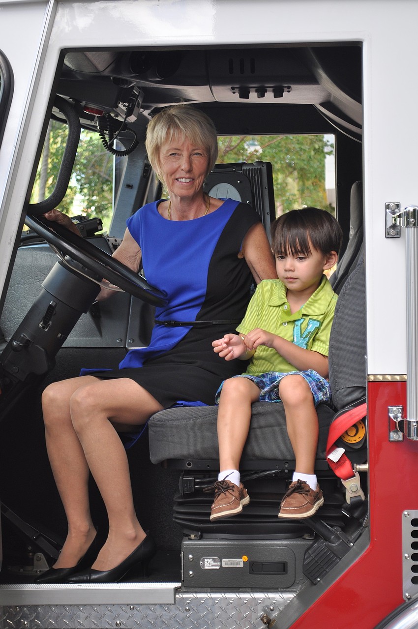 Dianne Ochiltree poses with Kygan Chung in a fire truck.